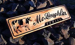 Dairy Fence sign macrocarpa with carving of cow and script font